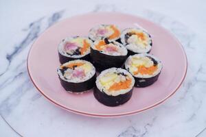 Sushi rolls on a plate on a white background. Japanese food photo