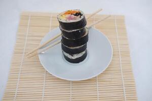 Sushi rolls on a plate on a white background. Japanese food photo