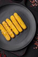 Delicious crispy cheese sticks with mozzarella, salt and spices, breaded and fried in oil photo