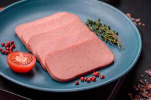 Delicious canned pink ham with salt, spices and herbs photo