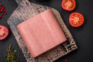 Delicious canned pink ham with salt, spices and herbs photo