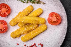 Delicious crispy cheese sticks with mozzarella, salt and spices, breaded and fried in oil photo