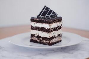 Delicious chocolate cake on a white plate photo