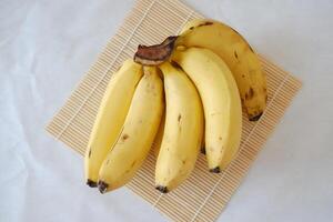 Bunch of bananas on a white marble table. Selective focus. photo