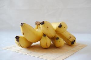 Bunch of bananas on a white marble table. Selective focus. photo