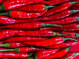 Red hot chilli peppers texture background. Close up view with copy space for design photo