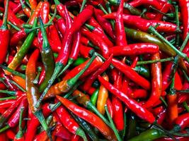 Red hot chilli peppers texture background. Close up view with copy space for design photo