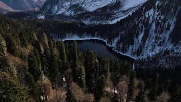 Aerial shot of a beautiful alpine lake in the mountains and the reflection in it video