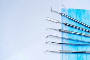 Surgical Instruments on Blue Cloth. A group of surgical instruments sitting on top of a blue cloth photo