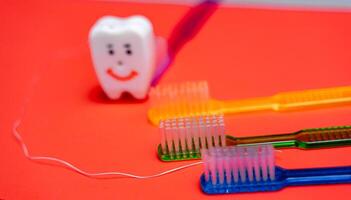 A Toothbrush, Toothpaste, and Toothpaste Tube on a Red photo