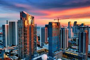 Aerial Sunset View of Tall Buildings in Miami, USA. Capture a breathtaking sunset view of the Miami skyline with its impressive tall buildings. photo