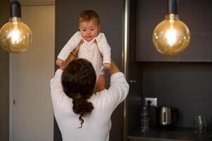 Loving mom caring of her newborn baby boy, enjoying playing together indoor. Mother and son. Family. Childcare Maternity photo