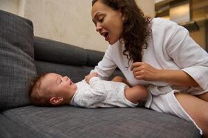 Close-up portrait of a happy young mother enjoying happy moments with her baby boy. Mom and kid face to face, together photo