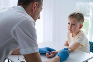 A male doctor makes an important Mantoux test on a child. The doctor measures the Mantoux test with a ruler for a little boy photo