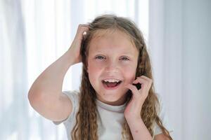 The child scratches his head with a rash. Itching from chickenpox in a girl. photo