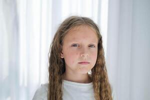 Portrait of a child with a rash from chickenpox. Girl with acne and cream on her face. photo