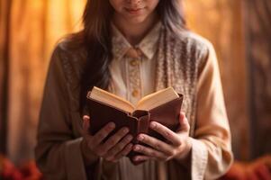 ai generado un mujer con un ligero marrón camisa participación un Biblia libro en frente de su con ambos manos. foto