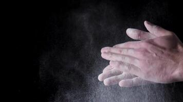 Chef Hands Clapping With Flour In Slow Motion on black background. Frame. Chef Claps Hands Together With Flour, Super Slow Motion video