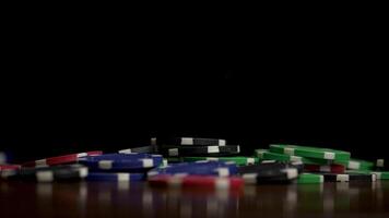 Falling poker chips isolated on black background. Colorful poker chips falling at the table on black background. Playing chips flying at the black background video