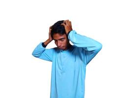 Dizzy face holding head of young Asian man in yellow shirt isolated on white background photo