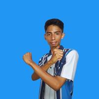 young asian male crossed arms with happy face isolated blue background photo