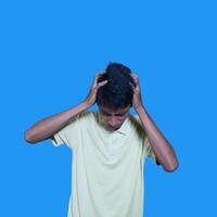 confused asian young man yellow t-shirt, isolated white background photo