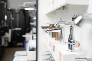 Modern kitchen and bathroom water faucets in the store photo