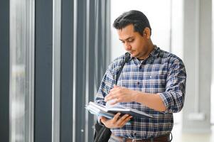 Portrait of cheerful male international Indian student with backpack. Education concept photo