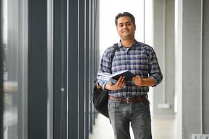 Portrait of cheerful male international Indian student with backpack. Education concept photo
