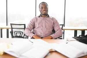 Male student sitting in university classroom. Man sitting in lecture in high school classroom. photo