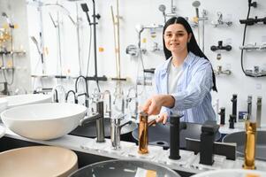 Woman choosing a shower head in a hardware store photo