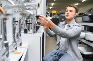 Man chooses a products in a sanitary ware store photo