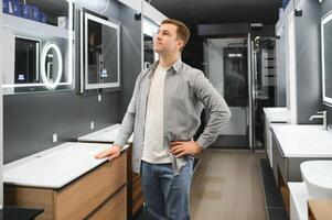 Man choosing a batgh sink with sales person photo