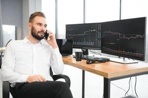 business man looking at the charts of the stock market of cryptocurrencies on the PC screen photo