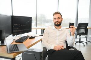 Financial Analysts and Day Traders Working on a Computers with Multi-Monitor Workstations with Real-Time Stocks, Commodities and Exchange Market Charts photo