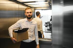 Worker feeling upset. Mature bearded office worker feeling upset after being resigned from successful company photo