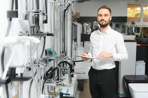 Portrait of a young man who sells faucets photo