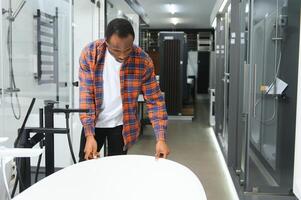 Young african american man choosing a bath photo