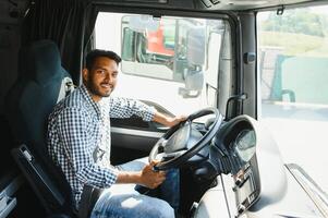 Happy professional truck driver driving his truck. Copy space. photo