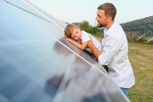 Father and his little son near solar panels. photo