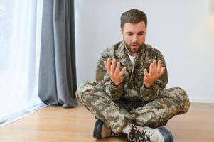 Depressed man recalling war days. Portrait of veteran soldier who has PTSD photo