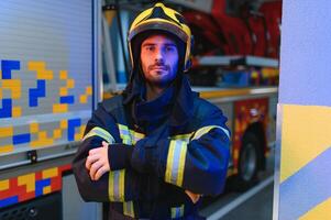 Photo of fireman with gas mask and helmet near fire engine