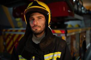 Photo of fireman with gas mask and helmet near fire engine