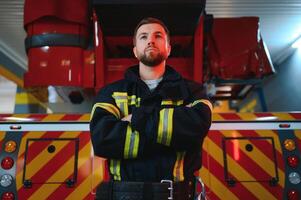 Photo of fireman with gas mask and helmet near fire engine