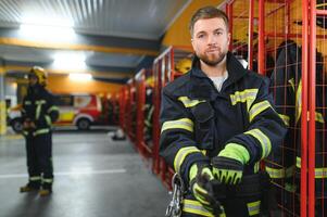 A firefighter puts on a fire uniform at the fire department photo