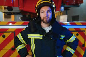 Photo of fireman with gas mask and helmet near fire engine