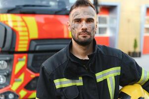 Firefighter rests after fighting a house fire photo