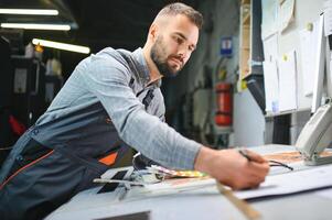 Print house worker controlling printing process quality and checking colors with magnifying glass photo