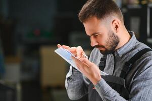 Print house worker controlling printing process quality and checking colors with magnifying glass photo