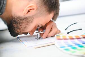 Graphic engineer or worker checking imprint quality in modern print shop photo